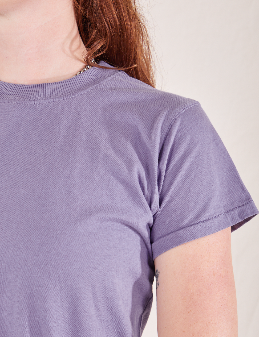 The Organic Vintage Tee in Faded Grape sleeve close up on Alex