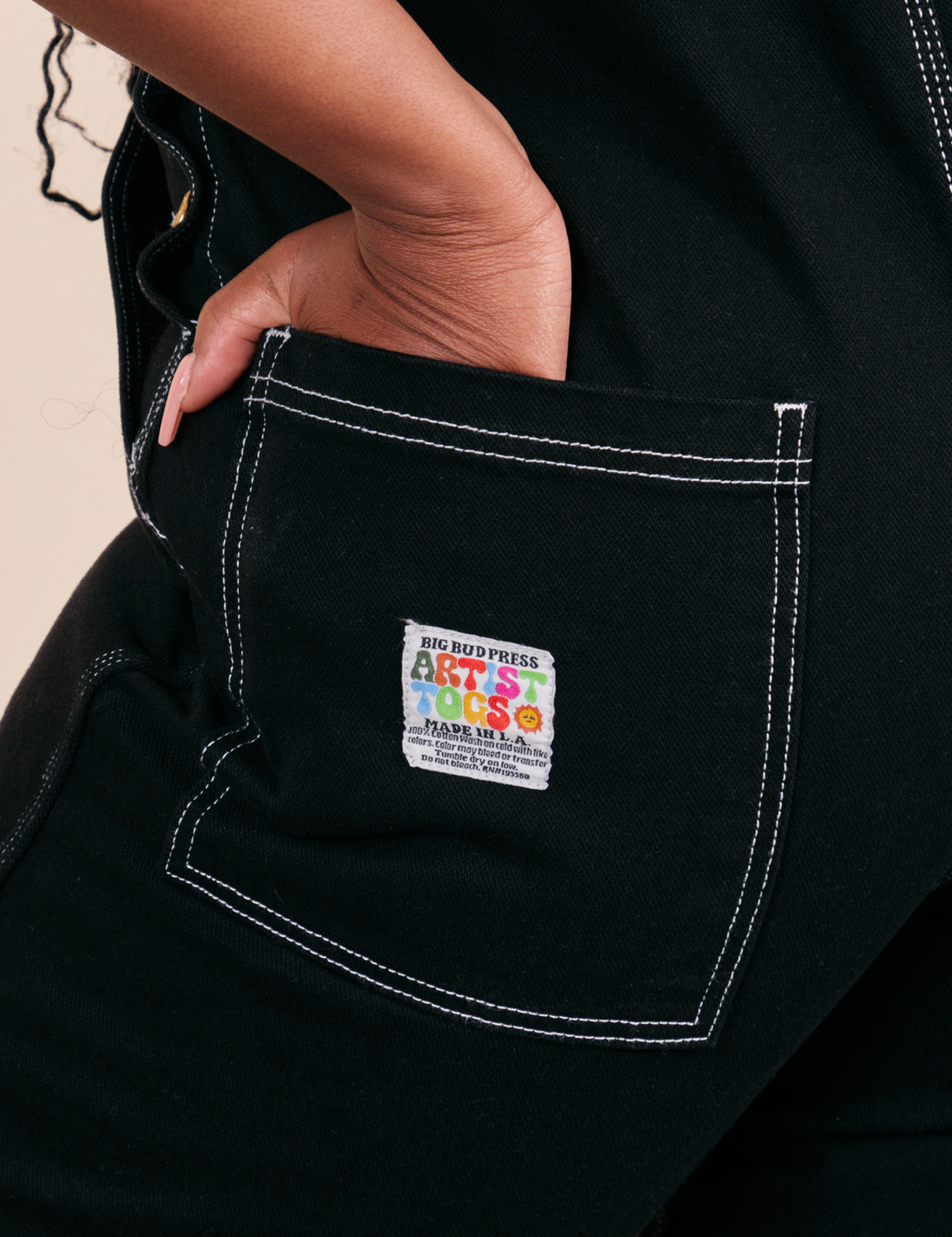 Original Overalls in Black back pocket close up with Artist TOGS label