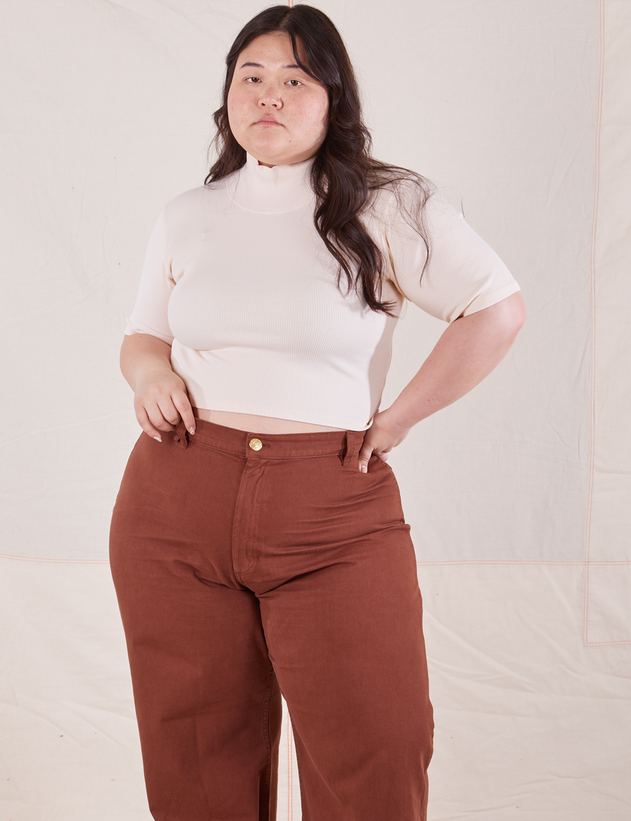 Ashley is wearing 1/2 Sleeve Essential Turtleneck in Vintage Off White and fudgesicle brown Bell Bottoms