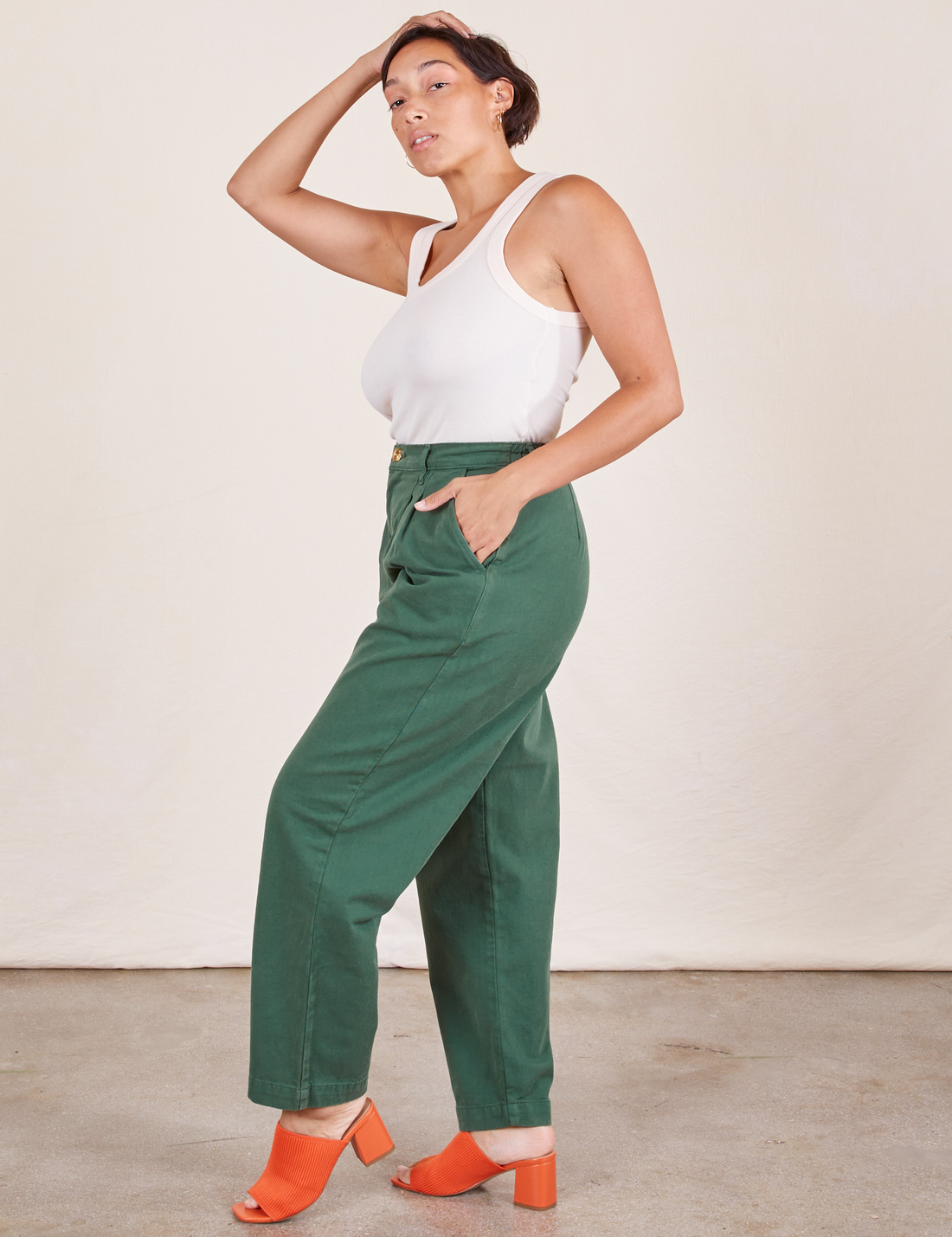 Side view of Heavyweight Trousers in Dark Emerald Green and vintage off-white Tank Top worn by Tiara