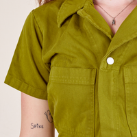 Front close up of Short Sleeve Jumpsuit in Olive Green worn by Alex
