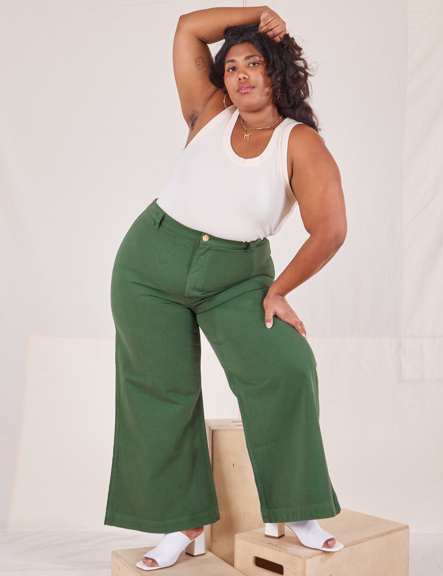 Morgan is wearing Bell Bottoms in Dark Emerald Green and vintage off-white Tank Top