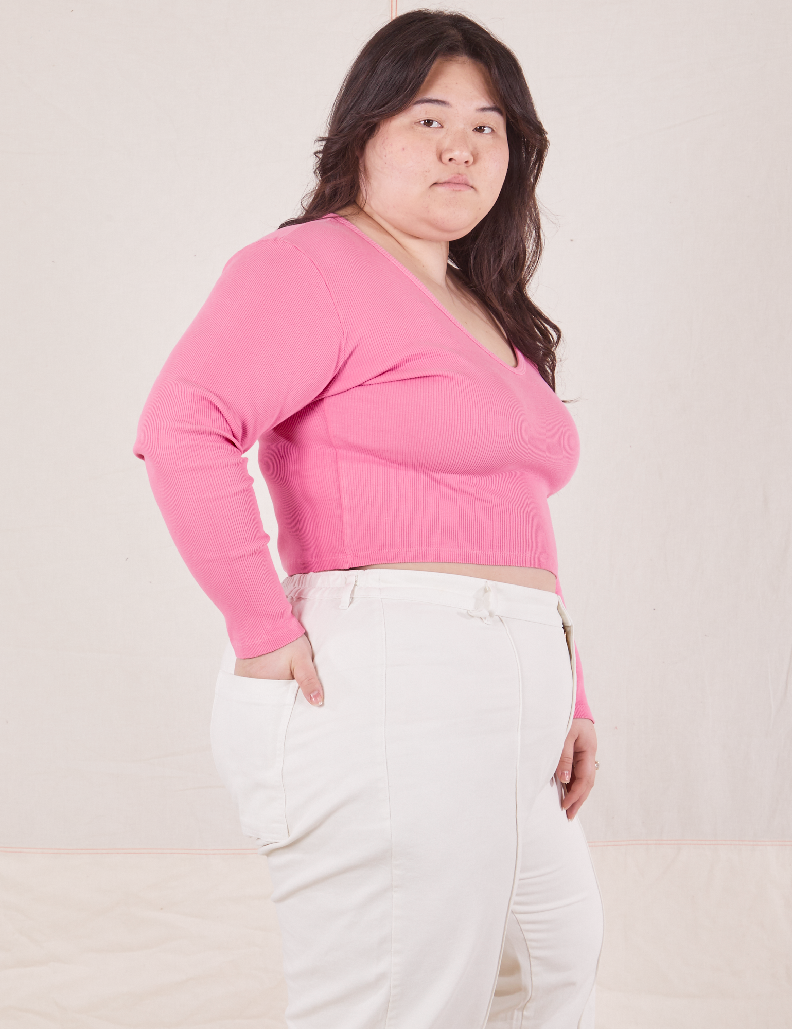 Side view of Long Sleeve V-Neck Tee in Bubblegum Pink worn by Ashley