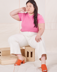 Organic Vintage Tee in Bubblegum Pink on Ashley wearing vintage off-white Western Pants sitting on wooden crate