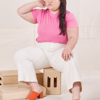 Organic Vintage Tee in Bubblegum Pink on Ashley wearing vintage off-white Western Pants sitting on wooden crate