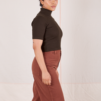 Side view of Mika wearing 1/2 Sleeve Essential Turtleneck in Espresso Brown and fudgesicle brown Bell Bottoms