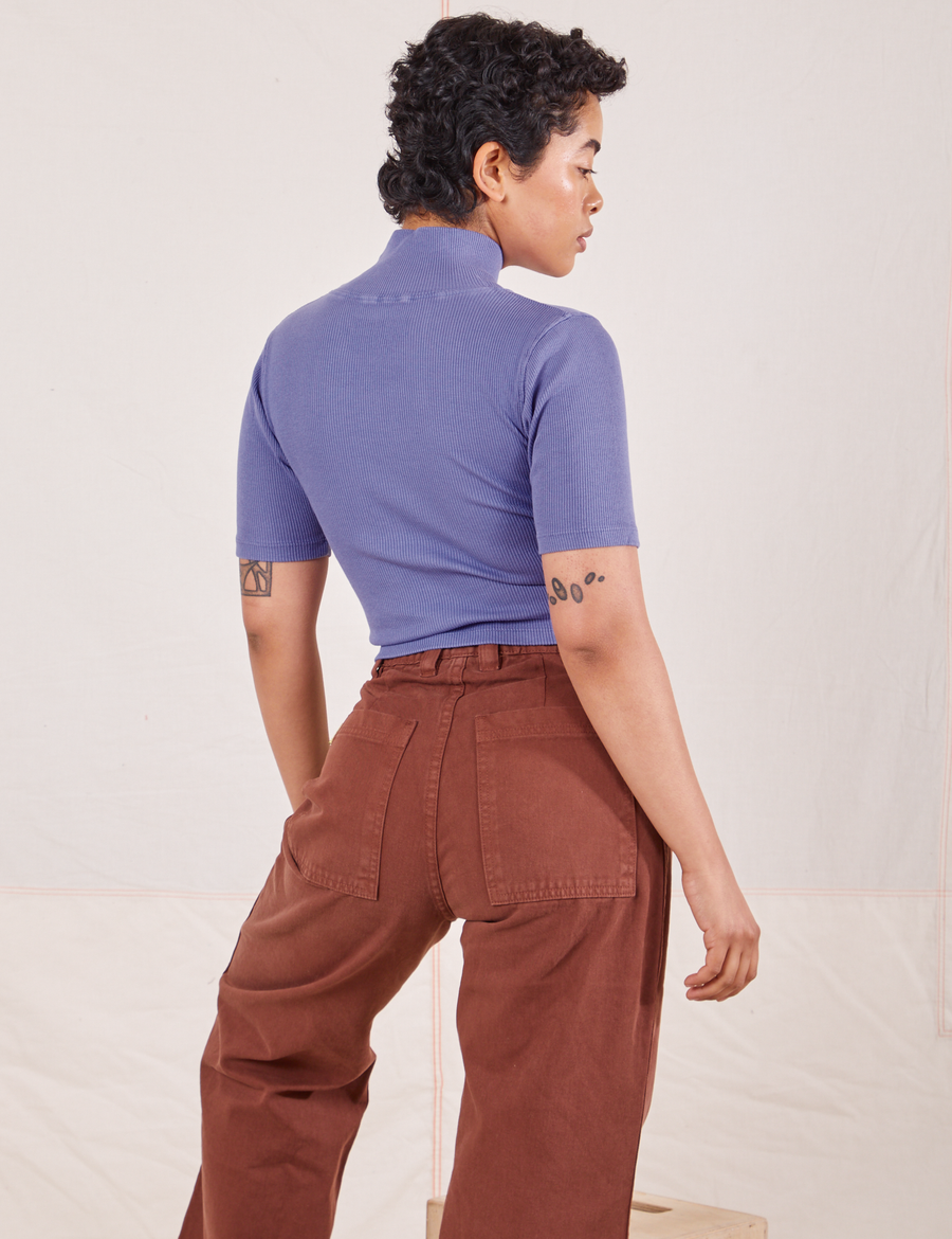Back view on Mika wearing 1/2 Sleeve Essential Turtleneck in Faded Grape and fudgesicle brown Bell Bottoms