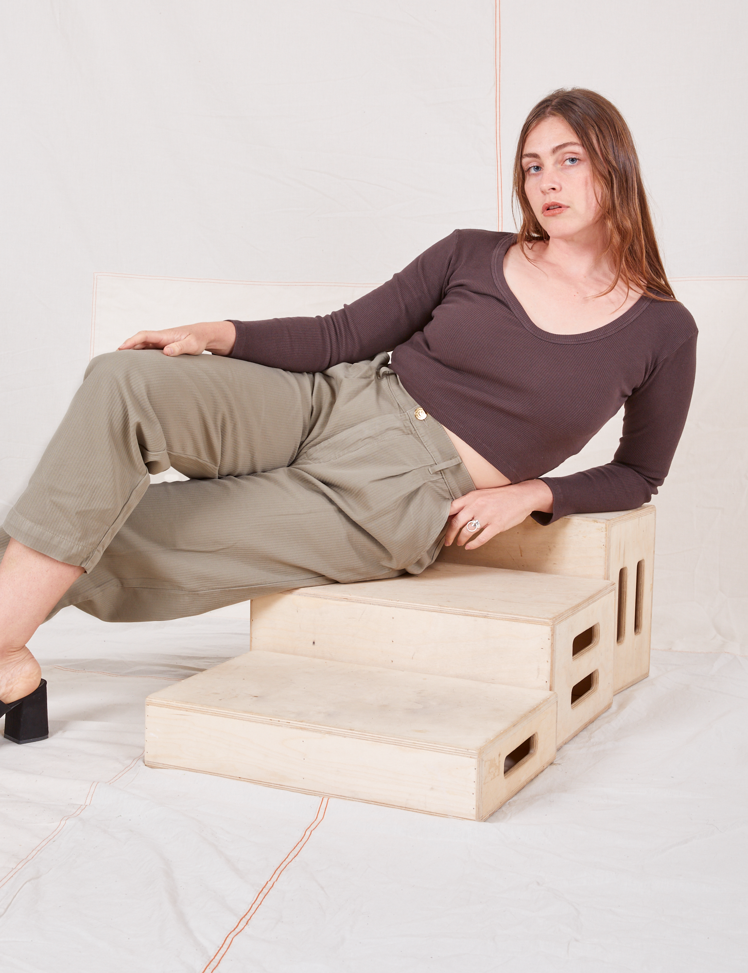Allison is wearing Heritage Trousers in Khaki Grey and espresso brown Long Sleeve V-Neck Tee