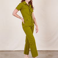 Side view of Short Sleeve Jumpsuit in Olive Green worn by Alex