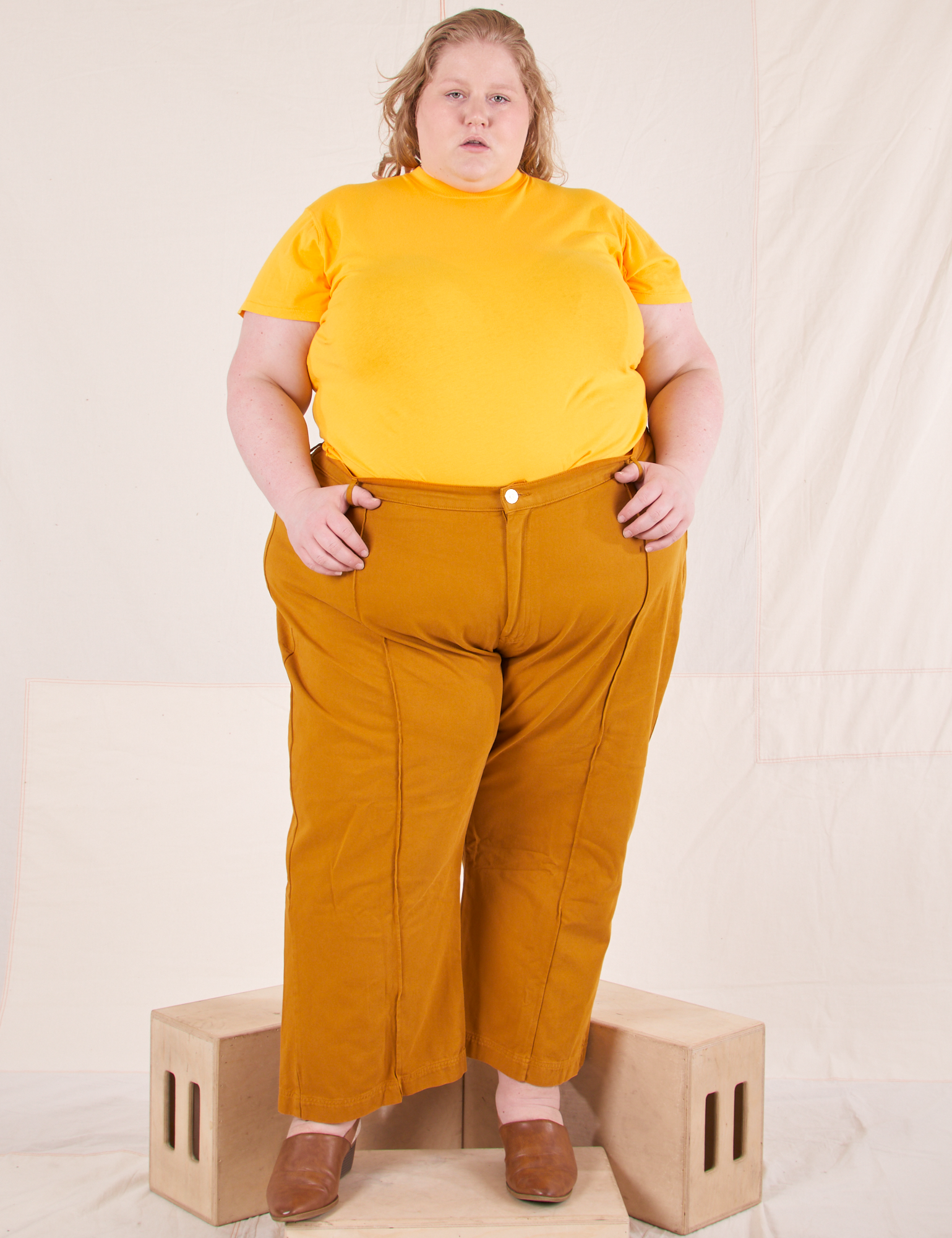 Catie is wearing 3XL Organic Vintage Tee in Sunshine Yellow paired with spicy mustard Western Pants