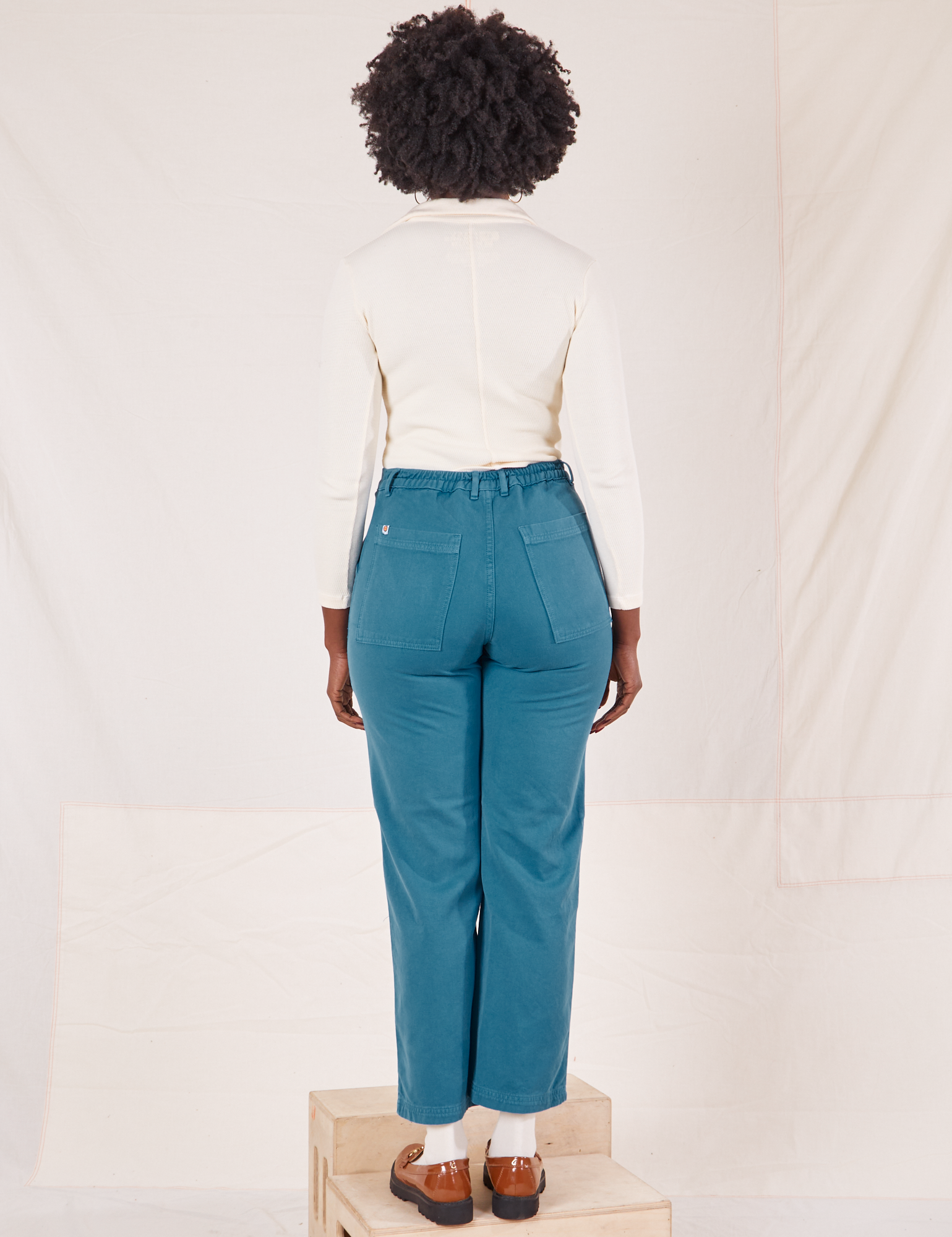 Back view of Organic Work Pants in Marine Blue worn by Reece