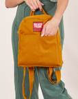 Mini Backpack in Spicy Mustard held by Tiara