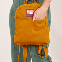 Mini Backpack in Spicy Mustard held by Tiara