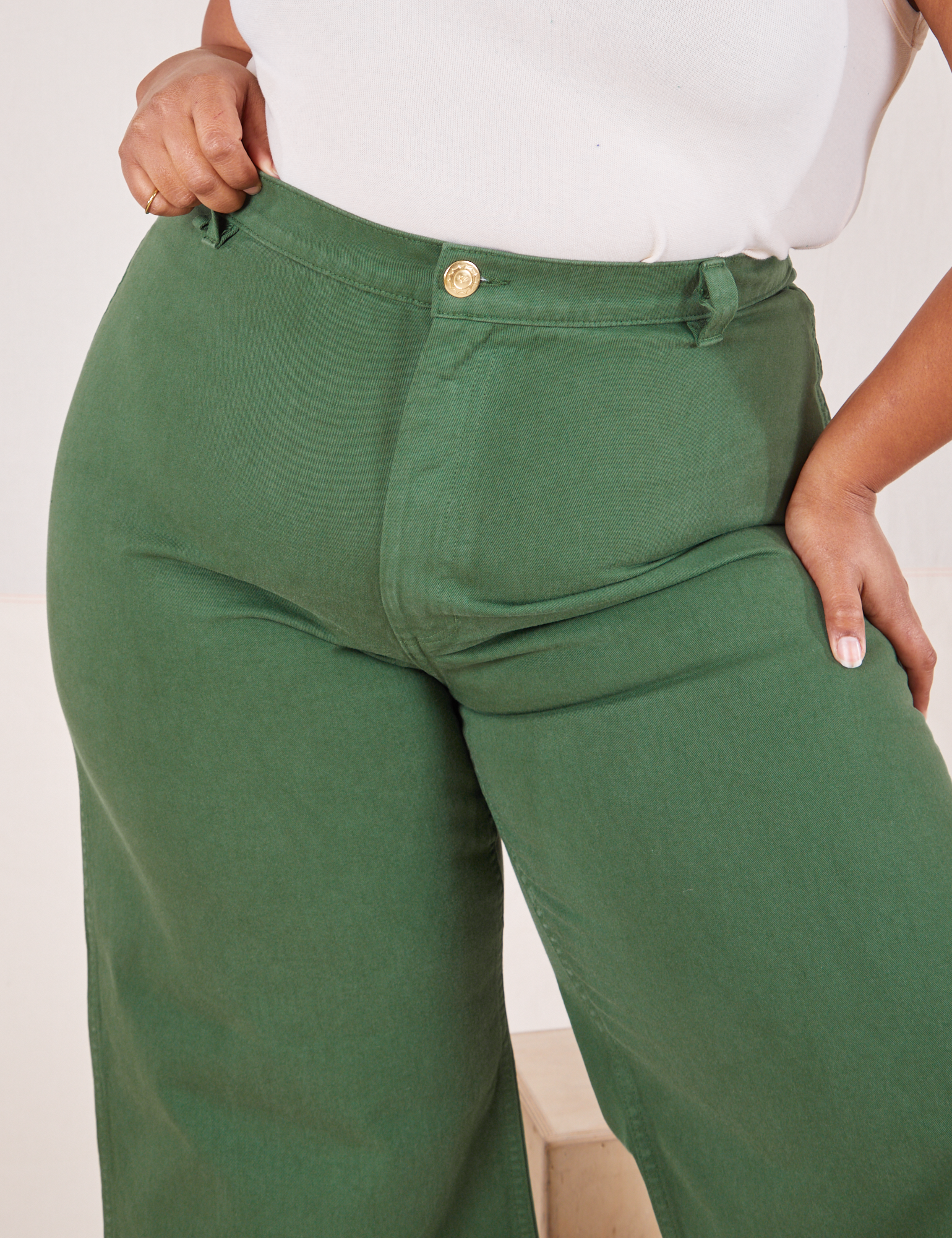Front close up of Bell Bottoms in Dark Emerald Green worn by Morgan