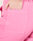 Work Pants in Bubblegum Pink back pocket close up. Worn by Allison with hand in pocket.