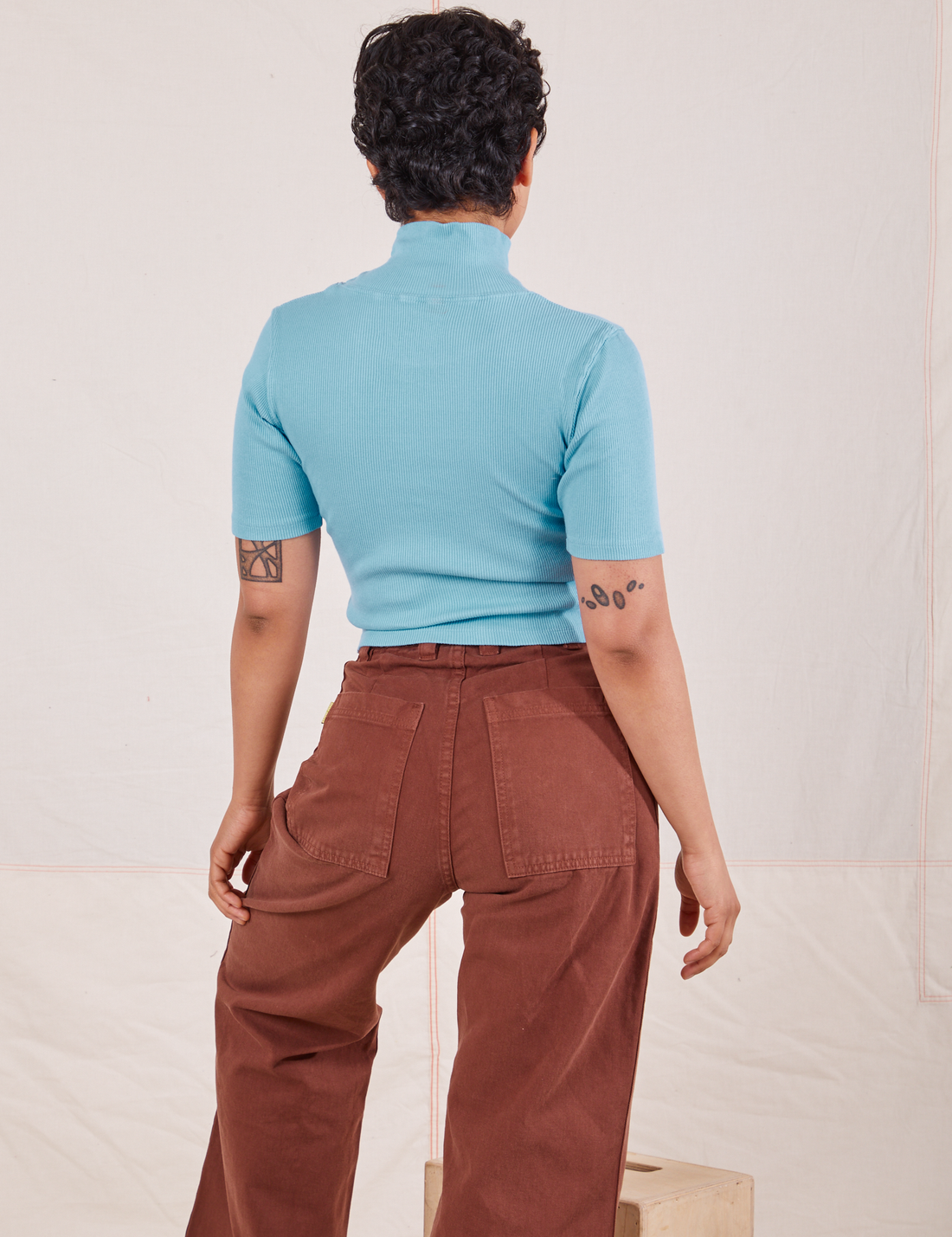 1/2 Sleeve Essential Turtleneck in Baby Blue back view on Mika wearing fudgesicle brown Bell Bottoms