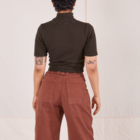 Back view of Mika wearing 1/2 Sleeve Essential Turtleneck in Espresso Brown and fudgesicle brown Bell Bottoms