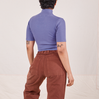 Back view of Mika wearing 1/2 Sleeve Essential Turtleneck in Faded Grape and fudgesicle brown Bell Bottoms