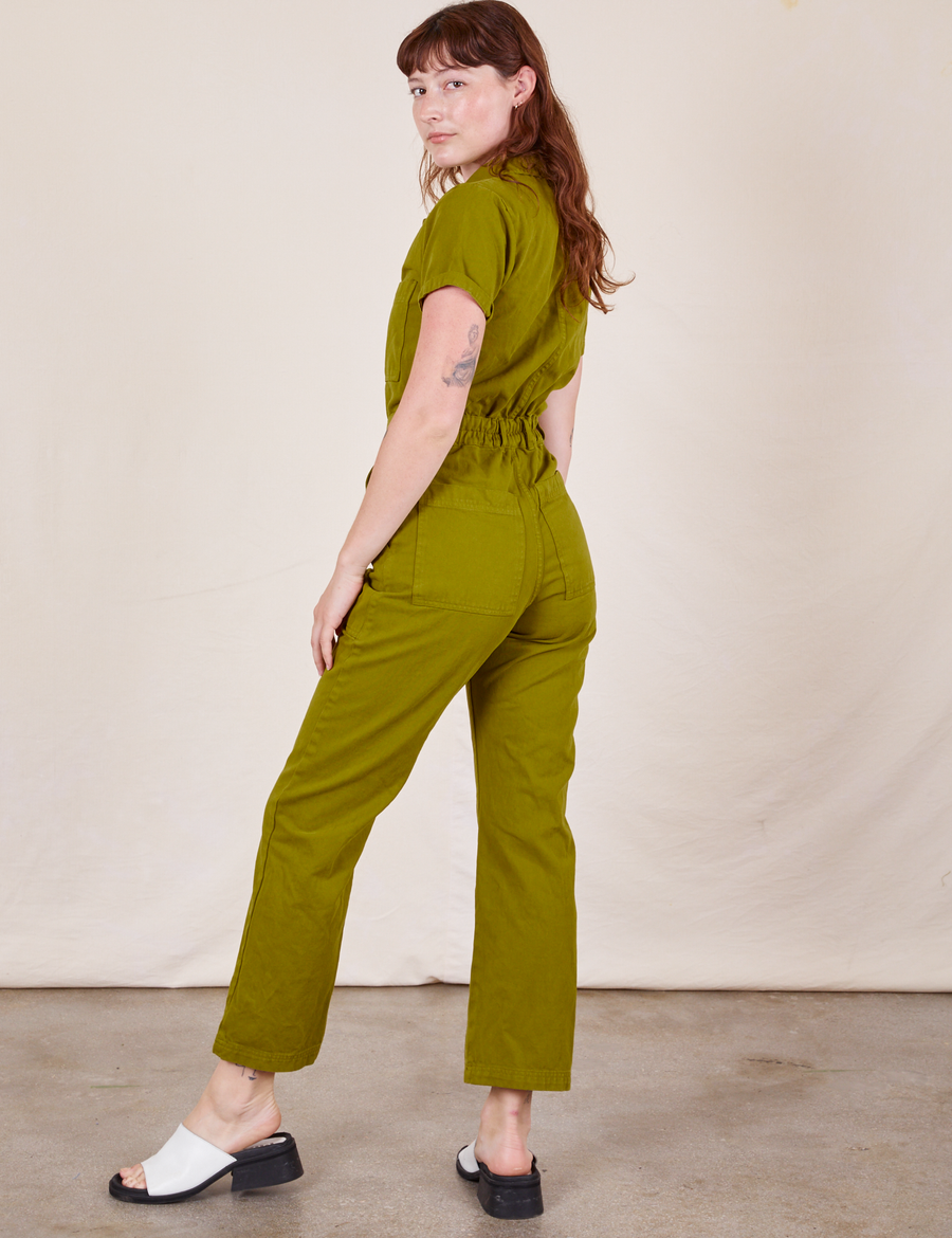 Back view of Short Sleeve Jumpsuit in Olive Green worn by Alex