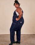 Side view of Original Overalls in Navy Blue worn by Morgan