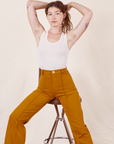 Alex is wearing Western Pants in Spicy Mustard and vintage off-white Tank Top