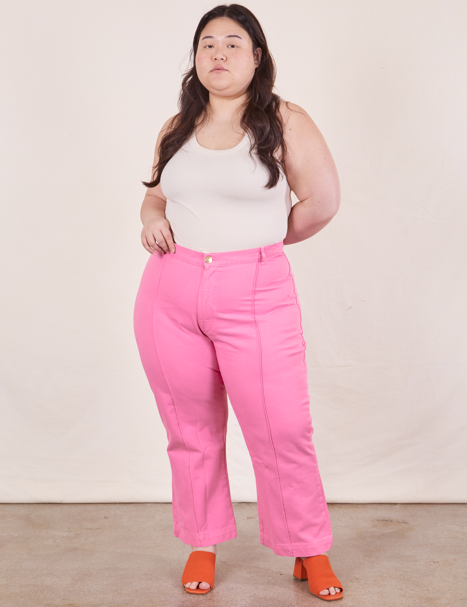 Ashley is 5&#39;7&quot; and wearing size 1XL Western Pants in Bubblegum Pink paired with vintage off-white Tank Top