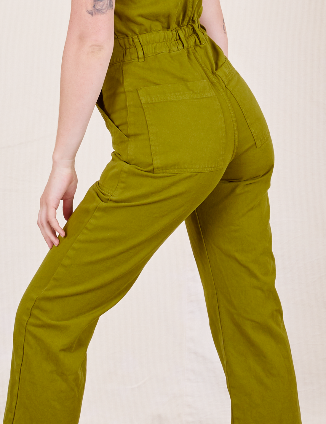 Short Sleeve Jumpsuit in Olive Green back view on Alex