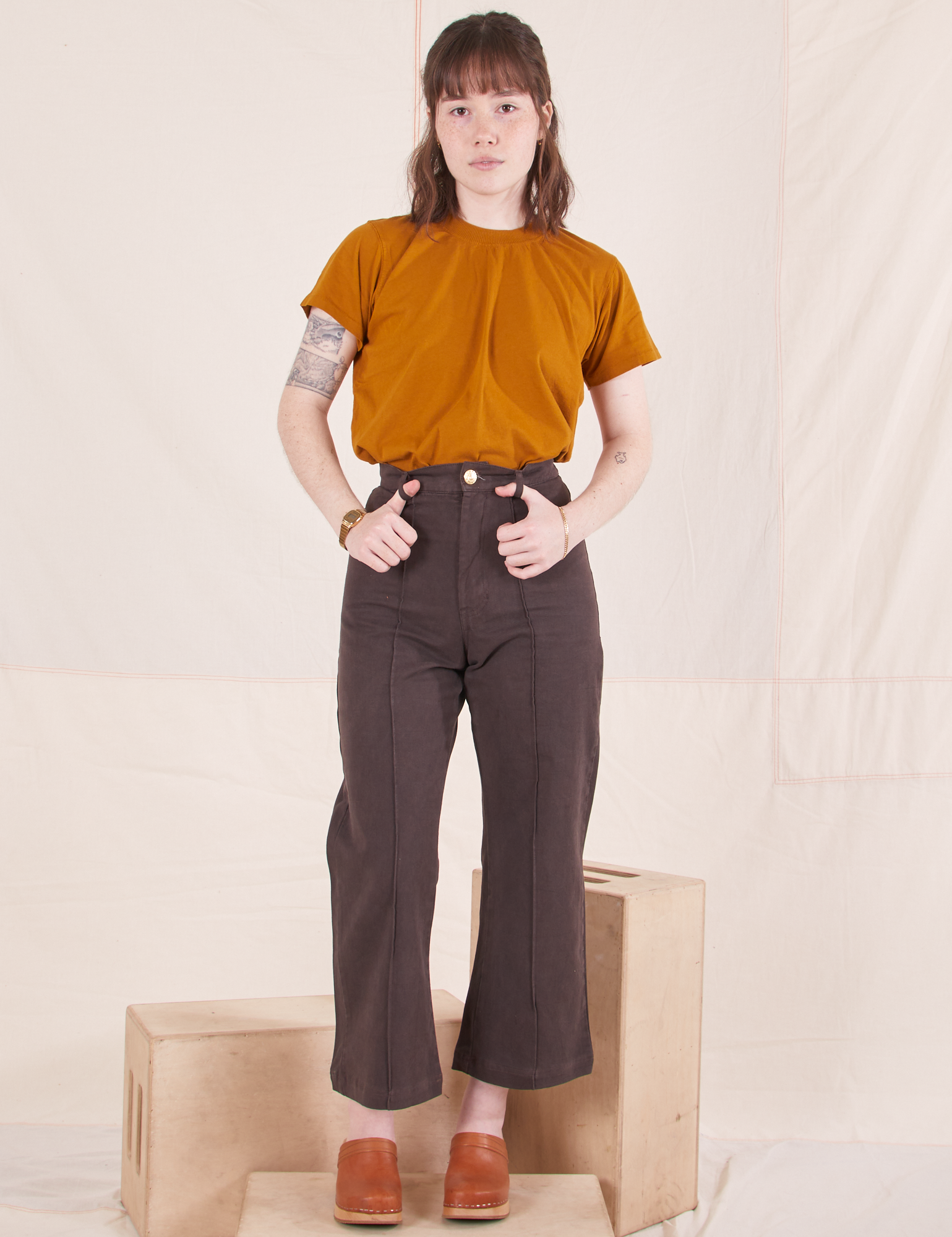 Hana is wearing P Organic Vintage Tee in Spicy Mustard paired with espresso brown Western Pants