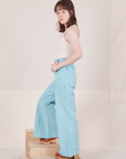 Side view of Bell Bottoms in Baby Blue and vintage off-white Tank Top worn by Hana