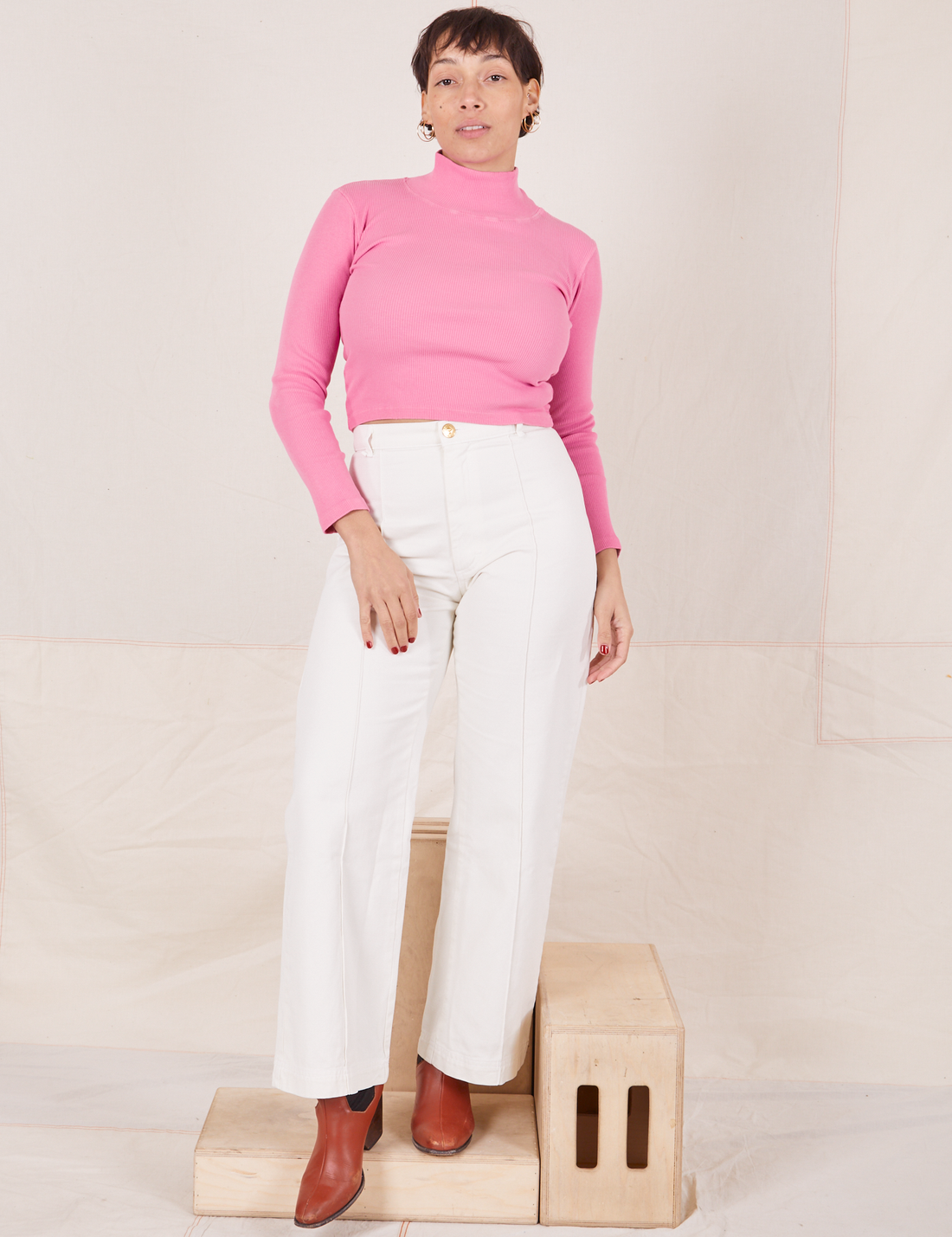 Tiara is wearing Essential Turtleneck in Bubblegum Pink and vintage off-white  Western Pants