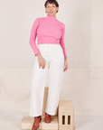 Tiara is wearing Essential Turtleneck in Bubblegum Pink and vintage off-white  Western Pants