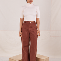 Mika is wearing size P 1/2 Sleeve Essential Turtleneck in Vintage Off White paired with fudgesicle brown Bell Bottoms