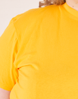 The Organic Vintage Tee in Sunshine Yellow front close up on Catie
