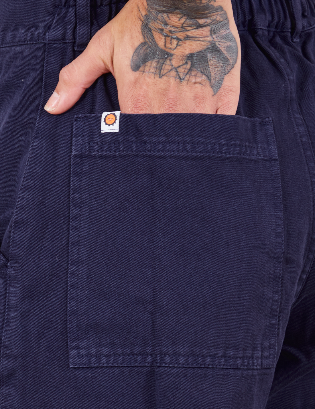 Short Sleeve Jumpsuit in Navy Blue hand in back pocket