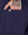 Short Sleeve Jumpsuit in Navy Blue hand in back pocket