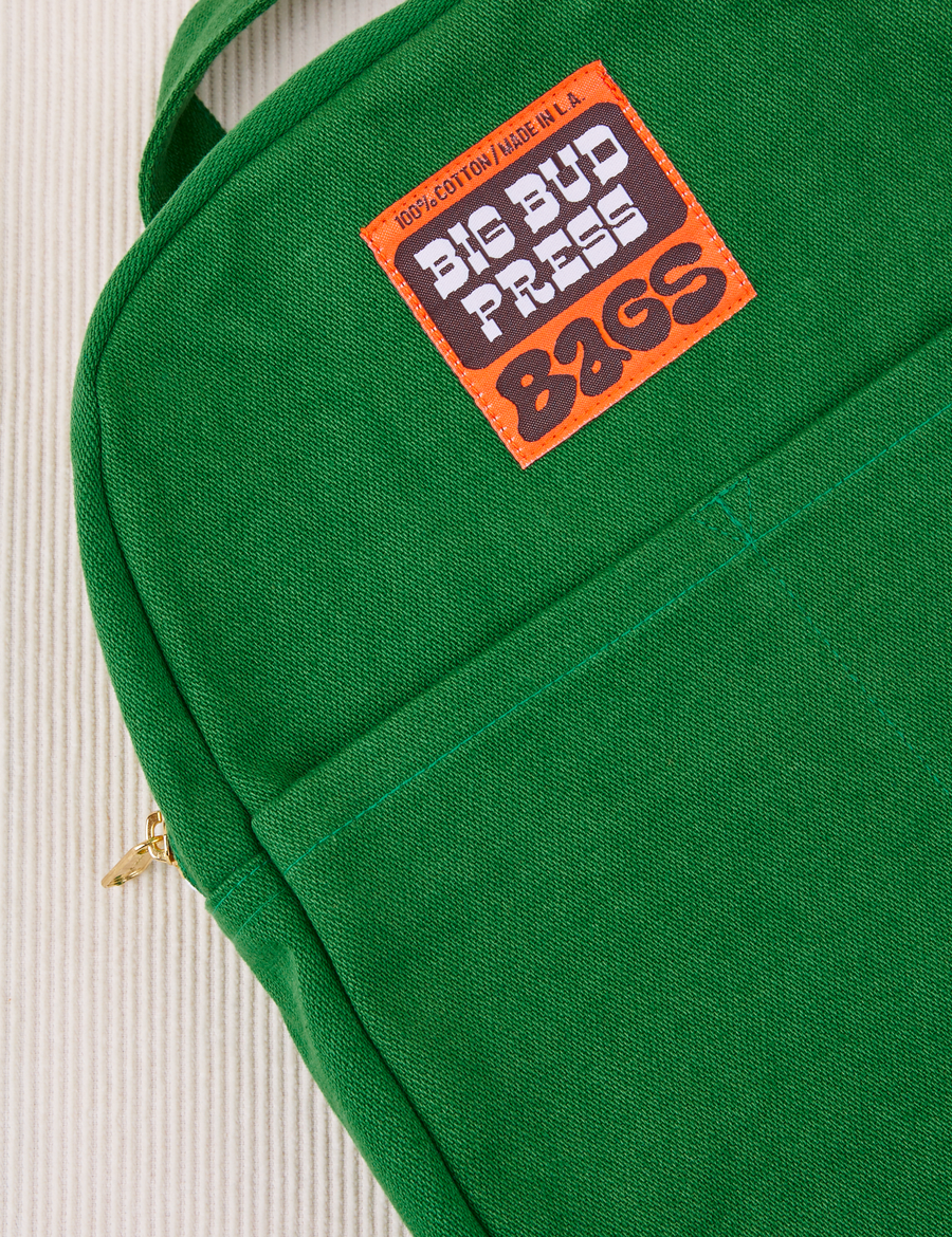 Mini Backpack in Forest Green close up with brown and orange Big Bud Press label