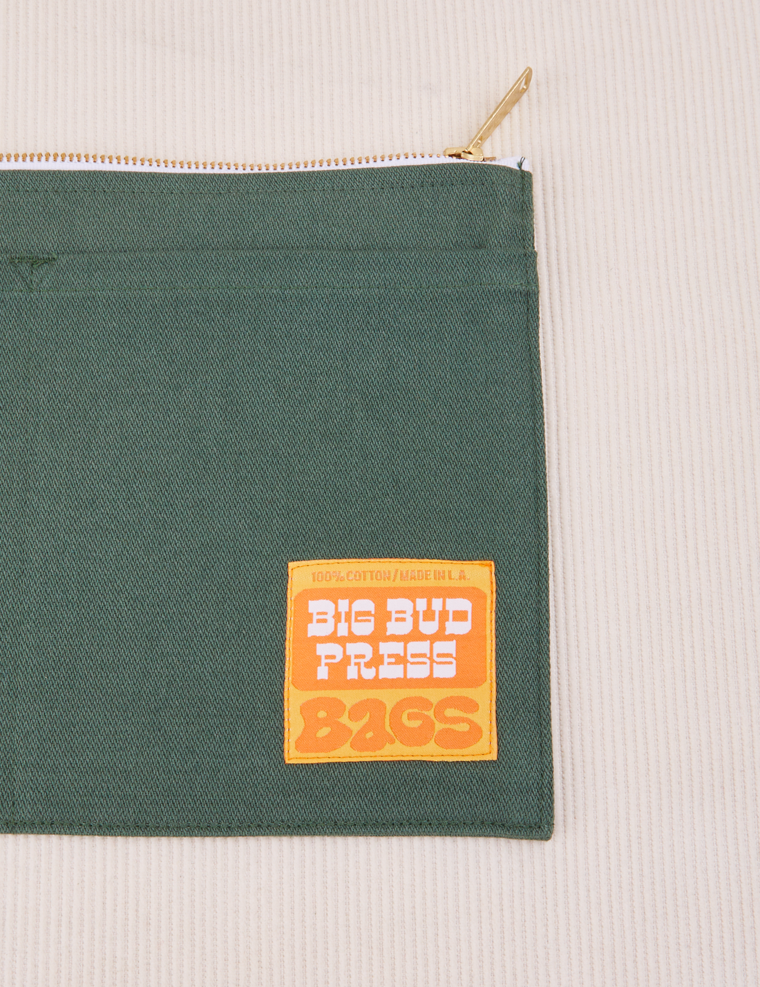Big Pouch in Dark Emerald green with Big Bud Press label in orange and yellow