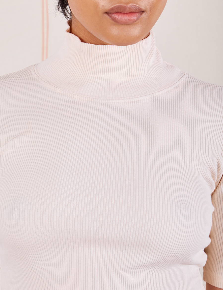Front close up of 1/2 Sleeve Essential Turtleneck in Vintage Off White on Mika