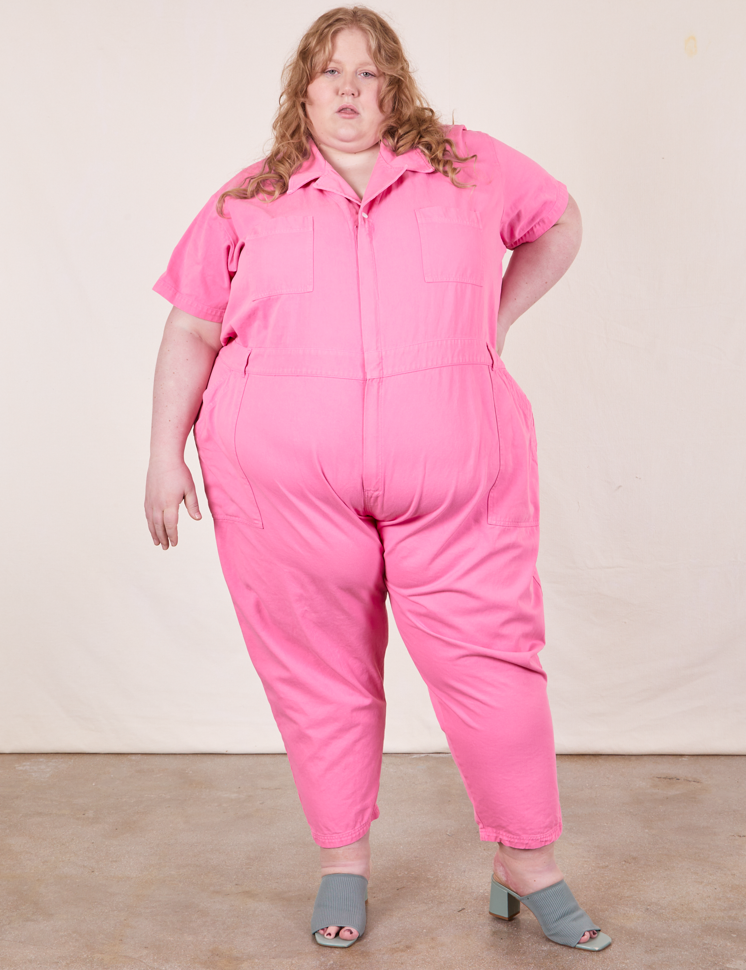 Catie is 5&#39;11&quot; and wearing size 5XL Short Sleeve Jumpsuit in Bubblegum Pink