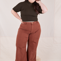 Ashley is wearing size M 1/2 Sleeve Essential Turtleneck in Espresso Brown paired with fudgesicle brown Bell Bottoms