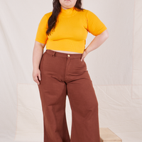 Ashley is wearing size M 1/2 Sleeve Essential Turtleneck in Sunshine Yellow paired with fudgesicle brown Bell Bottoms