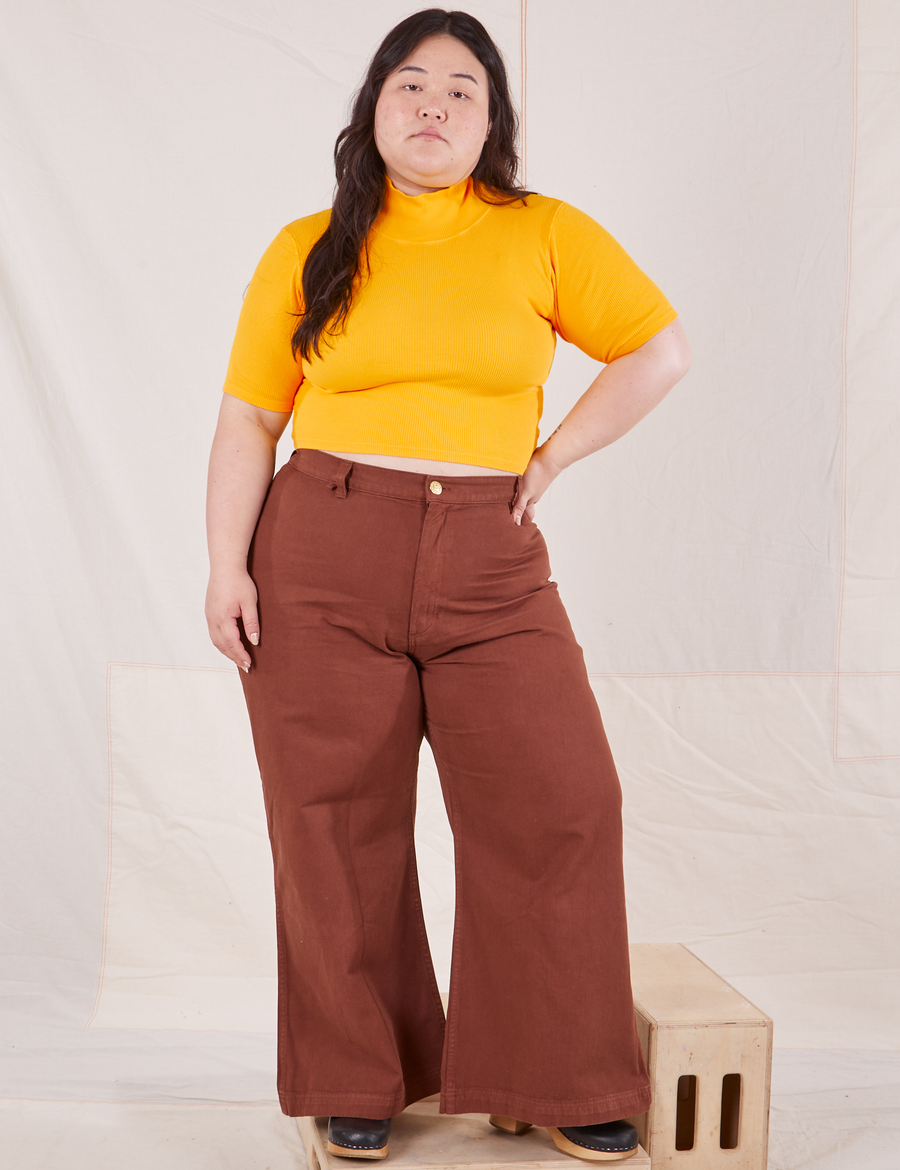 Ashley is wearing size M 1/2 Sleeve Essential Turtleneck in Sunshine Yellow paired with fudgesicle brown Bell Bottoms