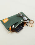 Big Pouch in Dark Emerald Green with items inside pouch