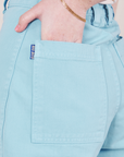Bell Bottoms in Baby Blue back pocket close up. Hana has her hand in the pocket.