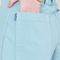 Bell Bottoms in Baby Blue back pocket close up. Hana has her hand in the pocket.