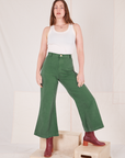 Allison is 5'10" and wearing XS Bell Bottoms in Dark Emerald Green paired with vintage off-white Tank Top