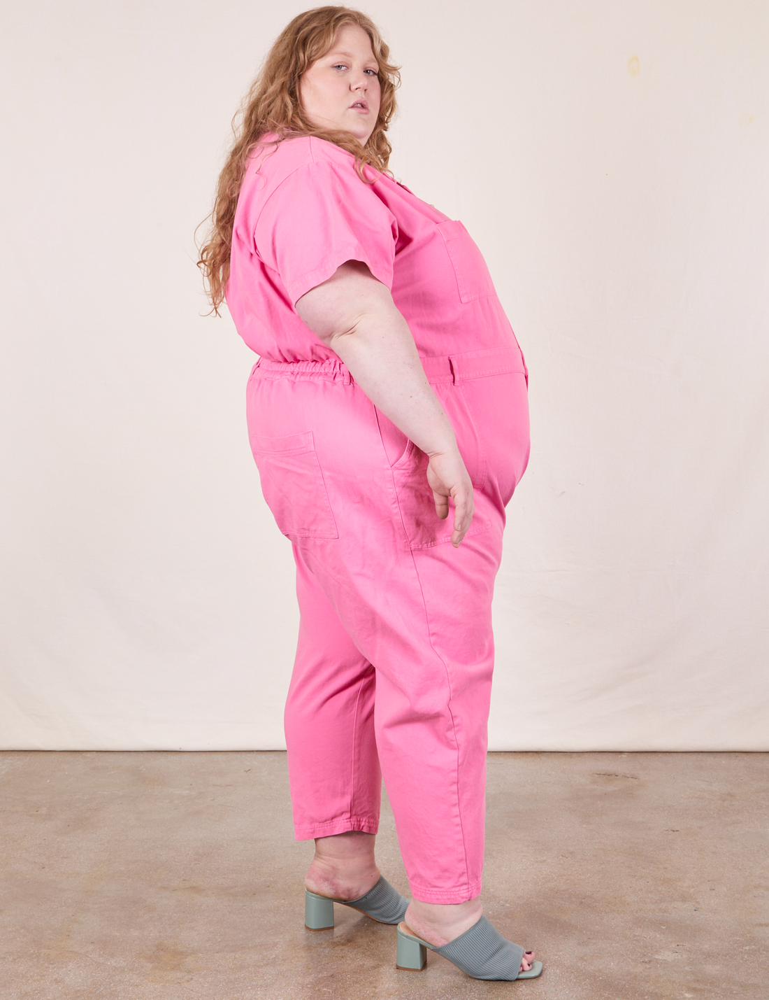 Short Sleeve Jumpsuit in Bubblegum Pink side view on Catie