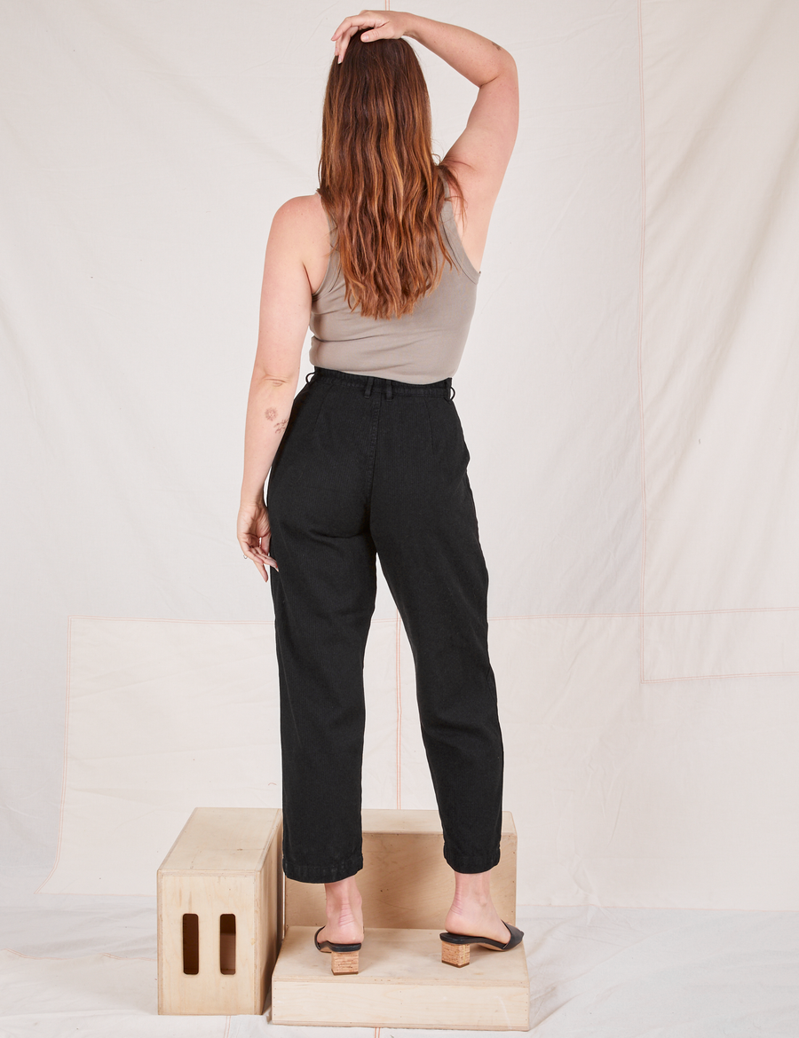 Back view of Heritage Trousers in Basic Black and khaki grey Tank Top worn by Allison