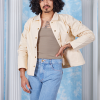 Jesse is wearing size S Vintage off-white David Neoclassical Work Jacket paired with khaki grey Tank Top underneath