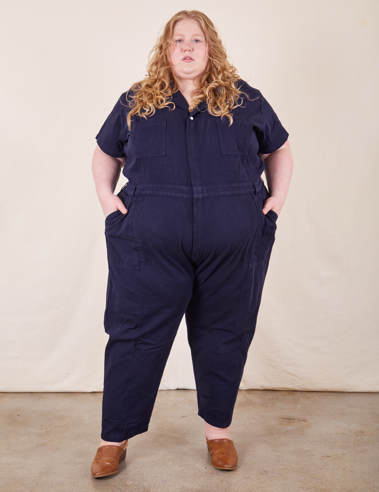 Catie is 5&#39;11&quot; and wearing 5XL Short Sleeve Jumpsuit in Navy Blue